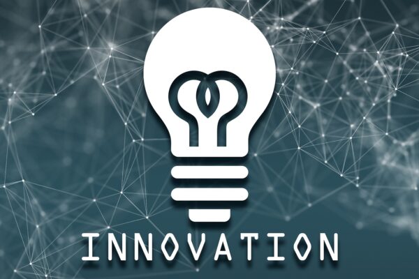 A lightbulb icon with the word "INNOVATION" on a grey network background.