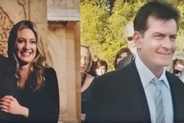 A man and a woman standing together and smiling.