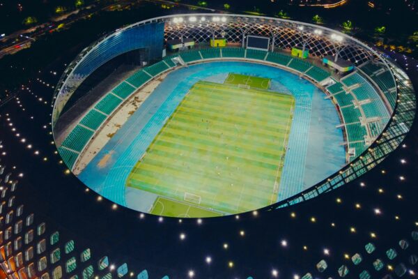 An overhead shot of a large, brightly lit sports stadium at night.