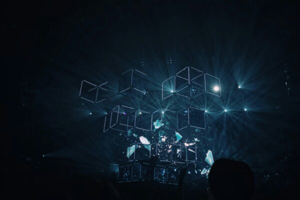 An abstract dark background with glowing blue interconnected dots.