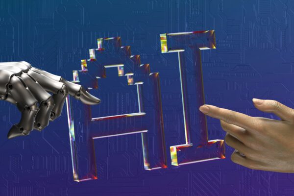 A transparent glass sculpture of the letters "AI" being touched by hands