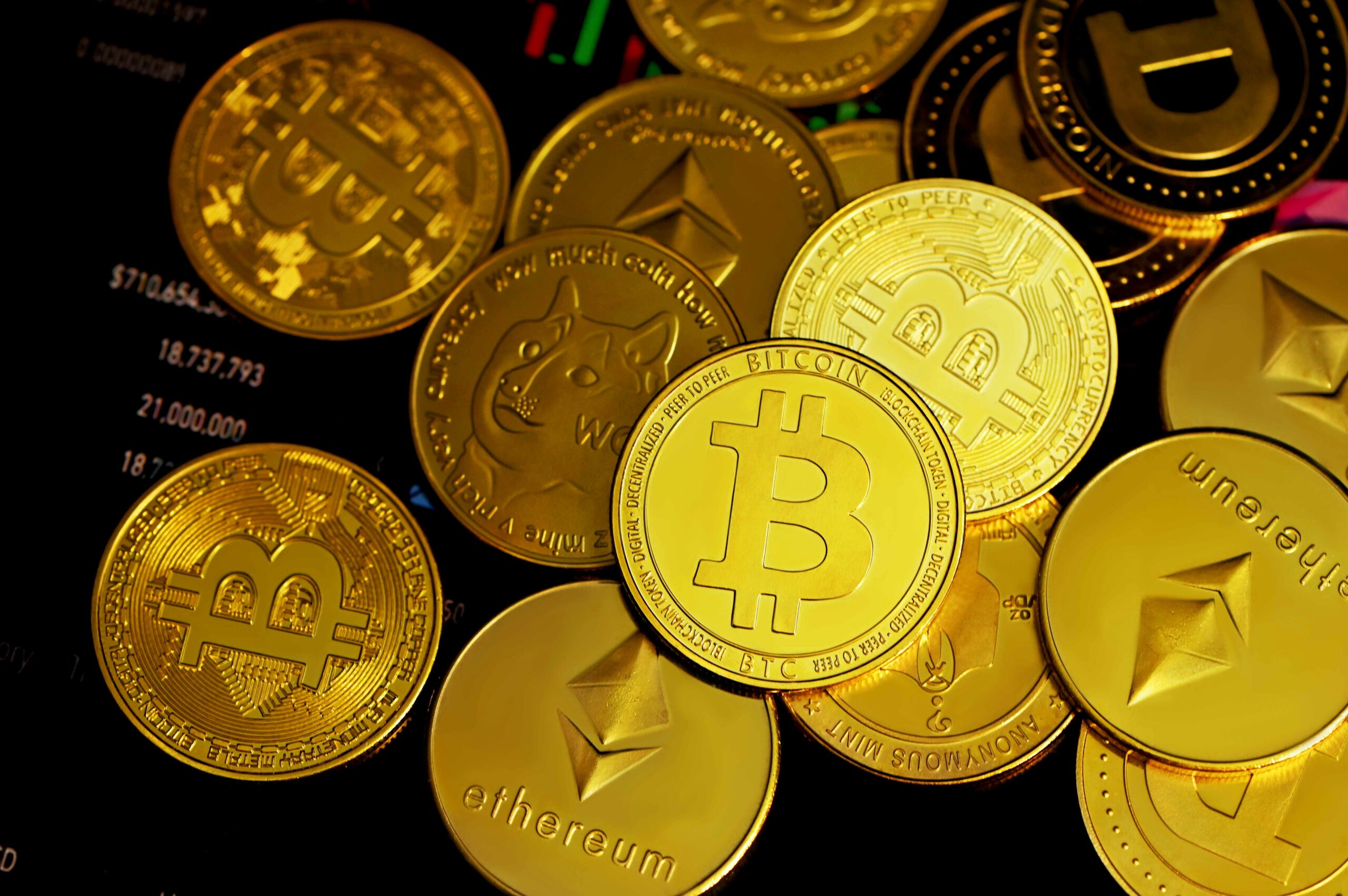 A pile of shining gold coins with the Bitcoin symbol.
