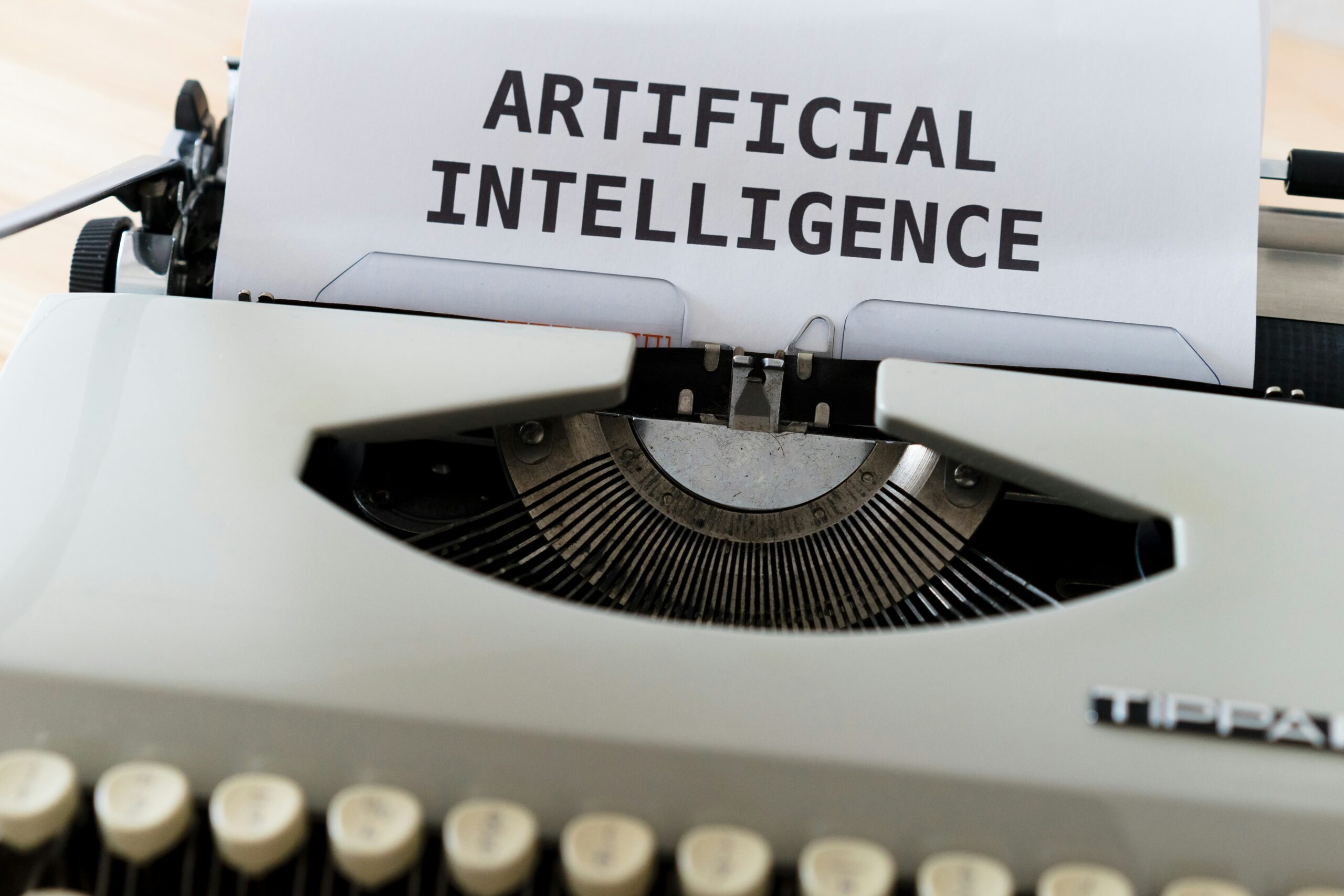 An old typewriter with a sheet of paper that says "Artificial Intelligence".
