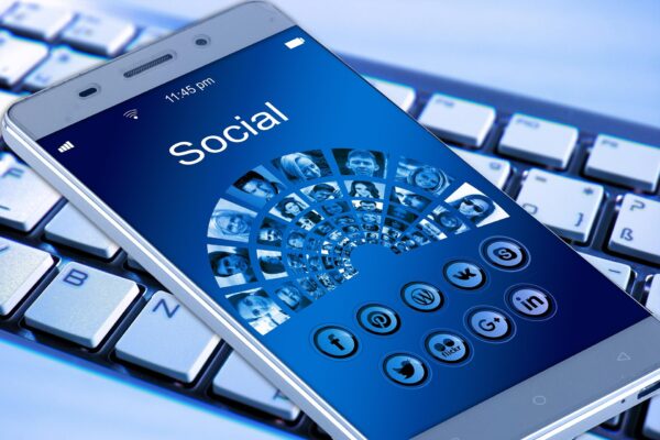 A smartphone screen displaying various social media icons like Facebook and Twitter.