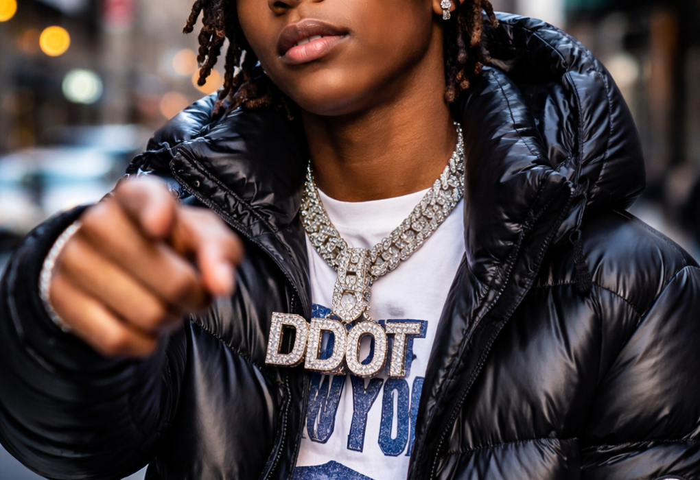 A young man in a puffer jacket wearing a large silver chain.