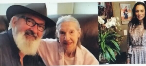 A man with a hat and an elderly woman smiling for a photo.