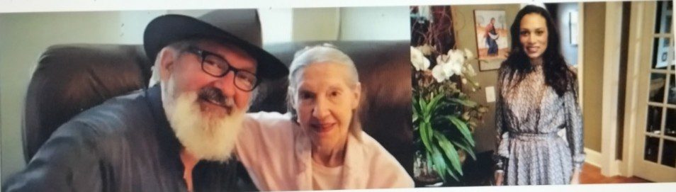 A man with a hat and an elderly woman smiling for a photo.
