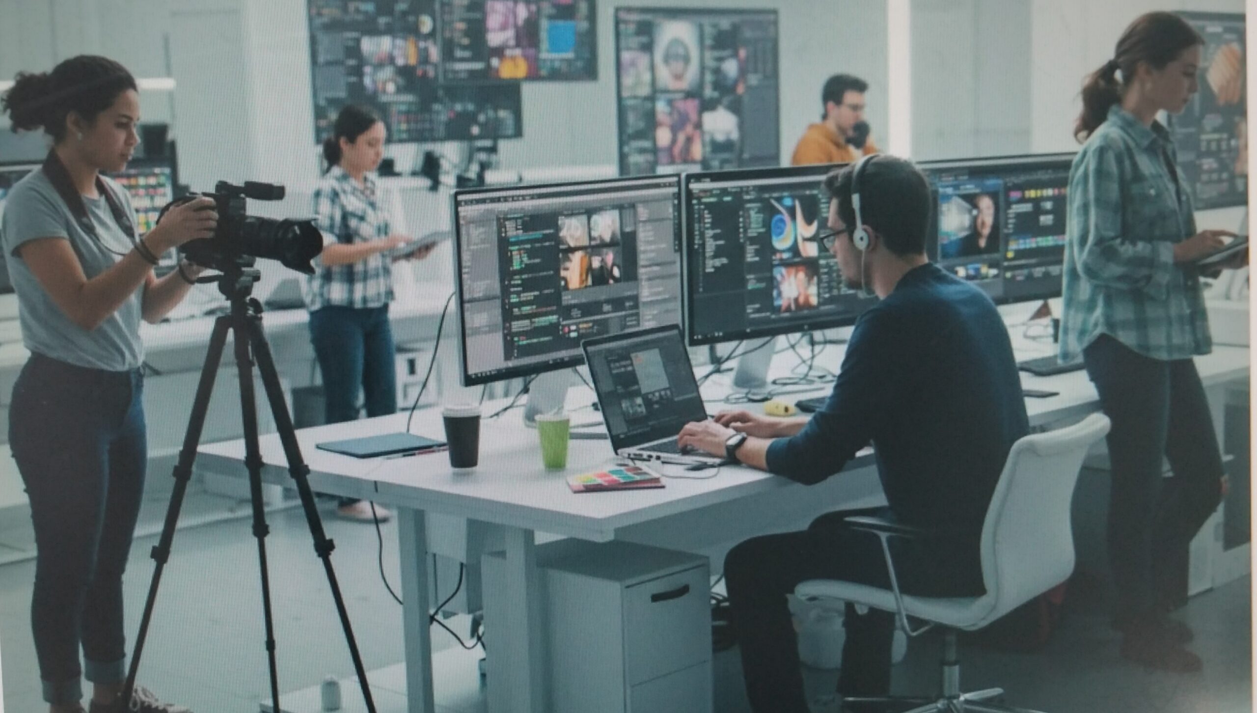 People working at computers in a modern office environment.
