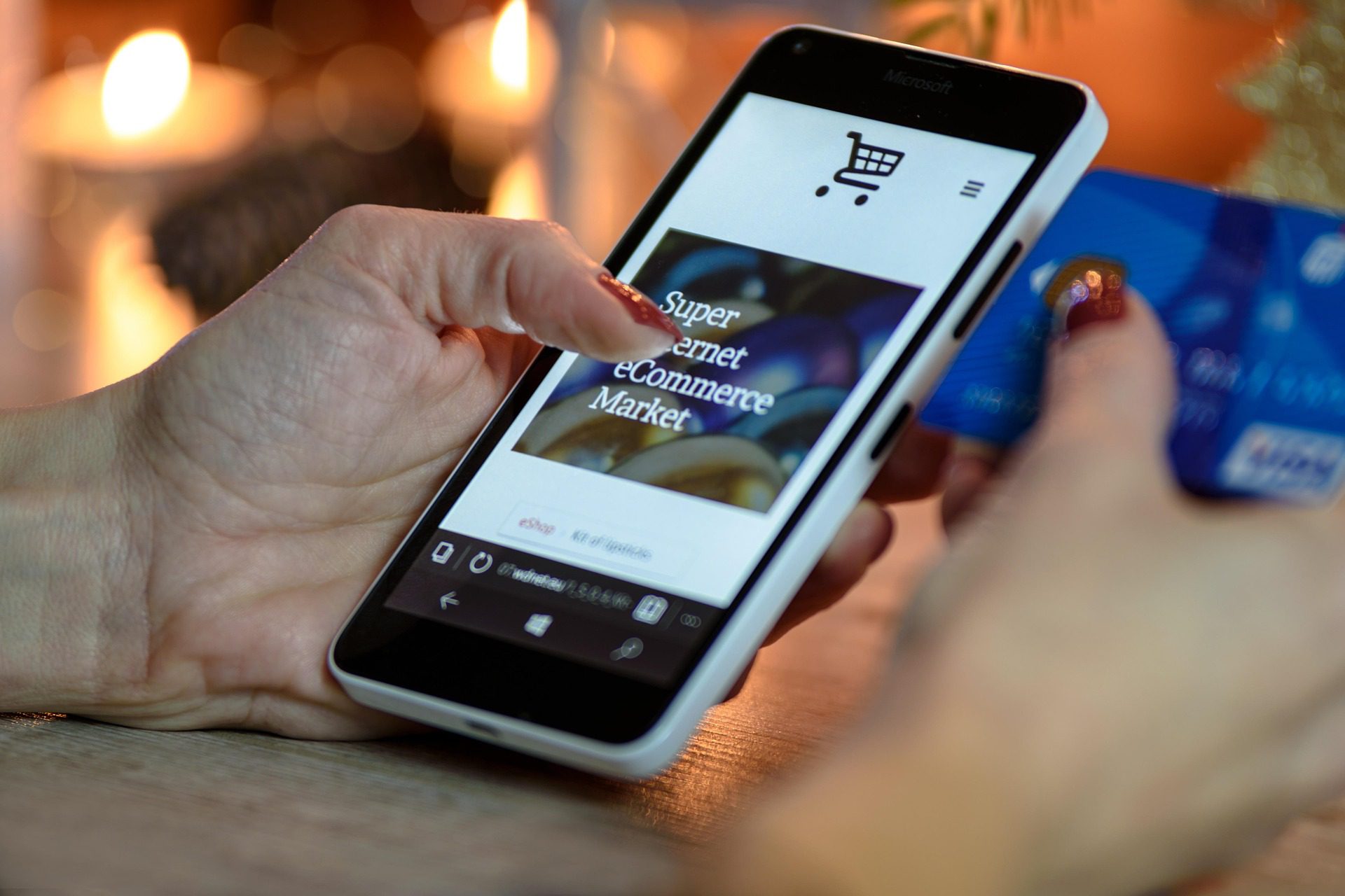 A person's hands using a smartphone to browse an e-commerce shopping app.